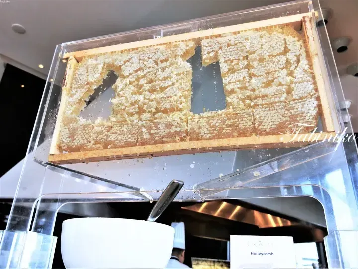 Fresh honeycomb displayed in a clear acrylic container at the TRACE hotel buffet.