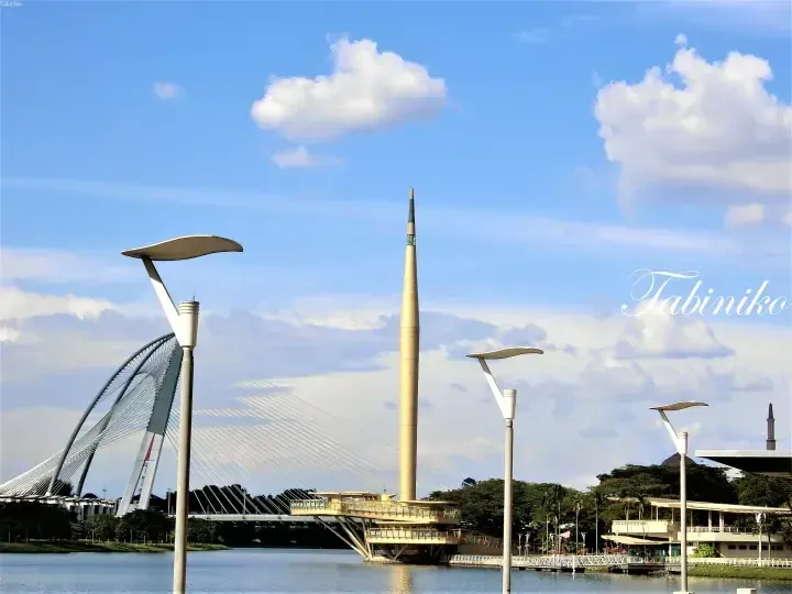 Titiwangsa Tower and Seri Wawasan Bridge at Putrajaya Lake under a blue sky
