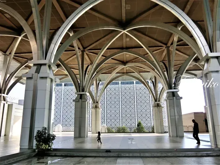 Interior view of the Putra Mosque showcasing its distinctive arches and intricate geometric patterns on the walls.