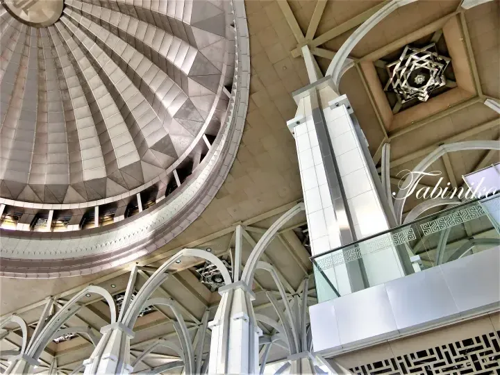 Interior view of Suria KLCC atrium featuring a geometric dome ceiling and modern architectural arches.