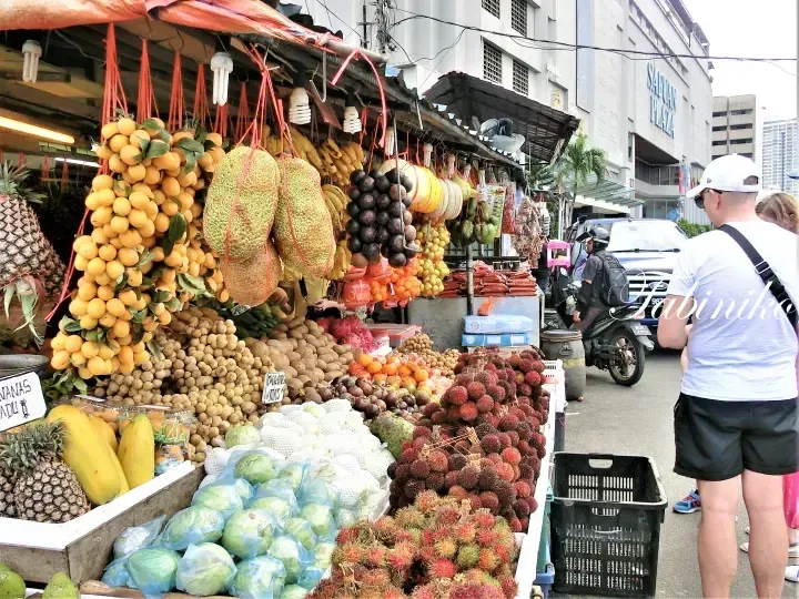 Vibrant street fruit stall in Kuala Lumpur displaying jackfruit, rambutan, and longan near Safuan Plaza.