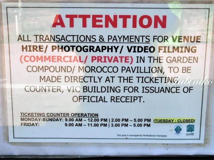 Sign at Putrajaya Botanical Gardens regarding venue hire and photography payments at the VIC Building ticketing counter.