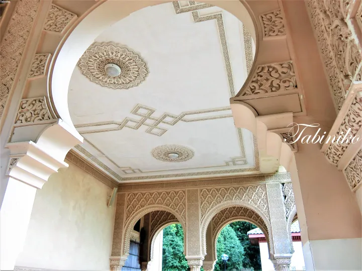 Ornate Moorish arches and intricate stucco ceiling details at a heritage property in Malaysia.