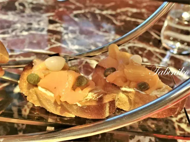 Smoked salmon bruschetta with capers on a marble table