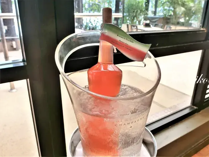 Pink drink in a Moet & Chandon ice bucket with a tag reading Viva Italia and Tabiniko.