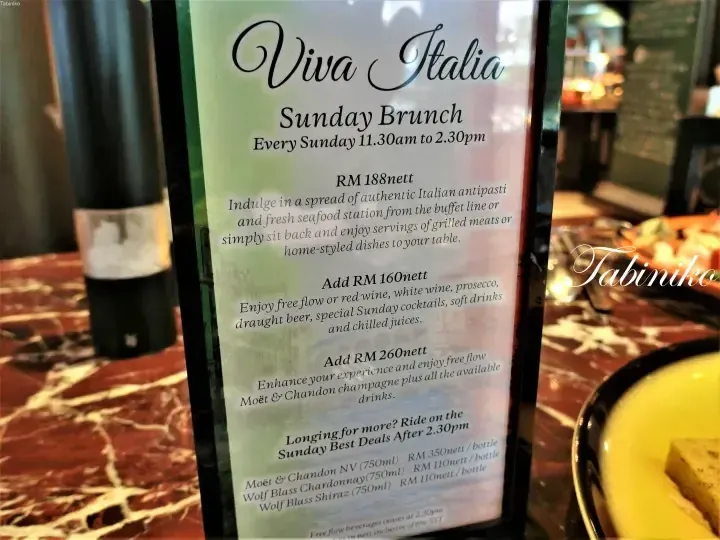 Viva Italia Sunday Brunch menu displaying RM188 pricing and drink packages on a marble table