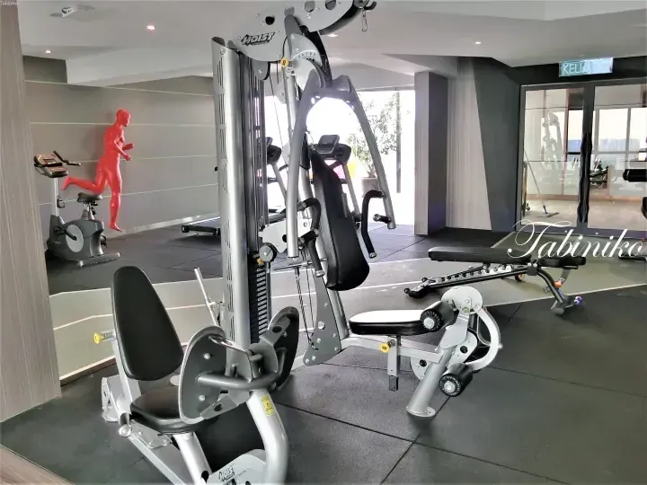 Modern gym interior with Hoist fitness equipment, a red running mannequin, and a KELUAR exit sign.