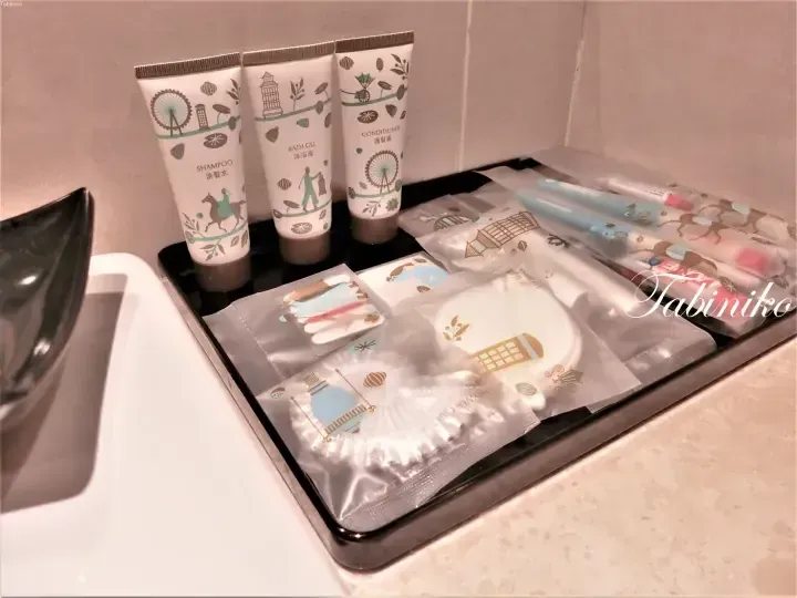 Amenities tray with shampoo, conditioner, bath gel, and toiletries at a Malaysia hotel bathroom.