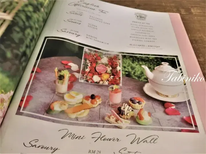Menu page for English Afternoon Tea at Petals Room featuring a tiered stand with sweets, scones, and savoury items alongside a teapot.