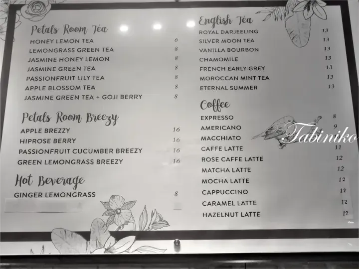 Menu board displaying Petals Room Tea, Breezy drinks, English Tea, and Coffee options with prices.