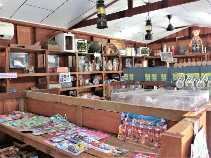 Rustic wooden shop interior displaying vintage items, toys, and souvenirs at Tabin Eco Farm in Tawau, Sabah.
