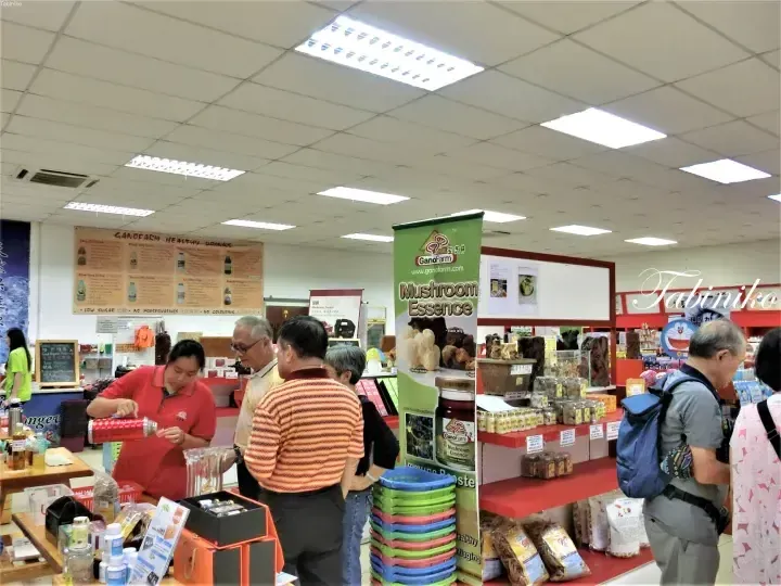 Customers browse GanoFarm mushroom products at a wellness store in Malaysia.