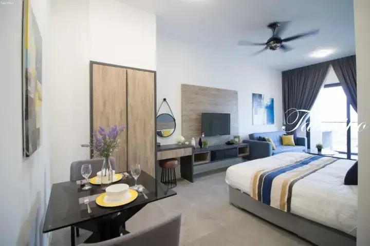 Modern studio apartment interior with dining table, TV area, and bed near balcony at Tablero.