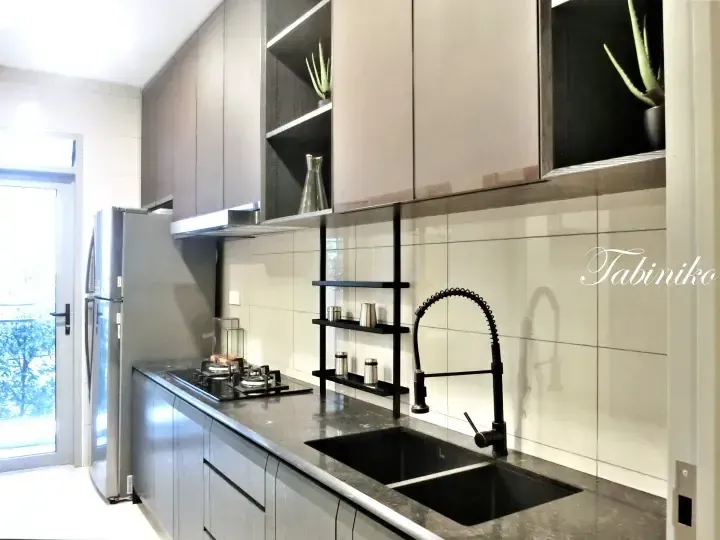 Modern kitchen featuring sleek grey cabinetry, a black double sink with a high-arc faucet, and a gas stove.