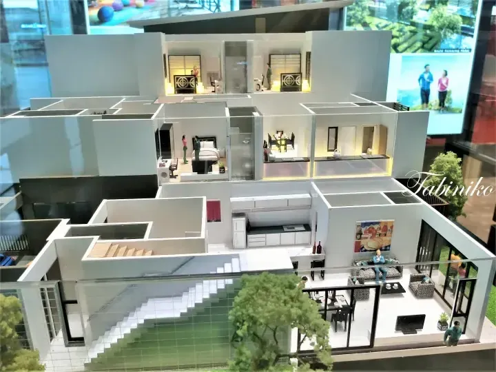 Architectural model showing a modern multi-level home interior with detailed rooms, furniture, and a swimming pool.
