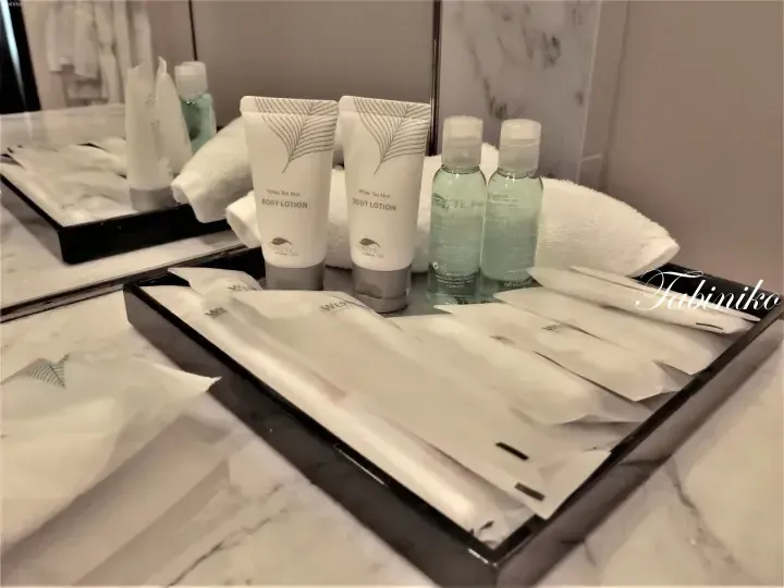 Westin Heavenly Spa White Tea Aloe body lotion and toiletries on a marble bathroom counter.