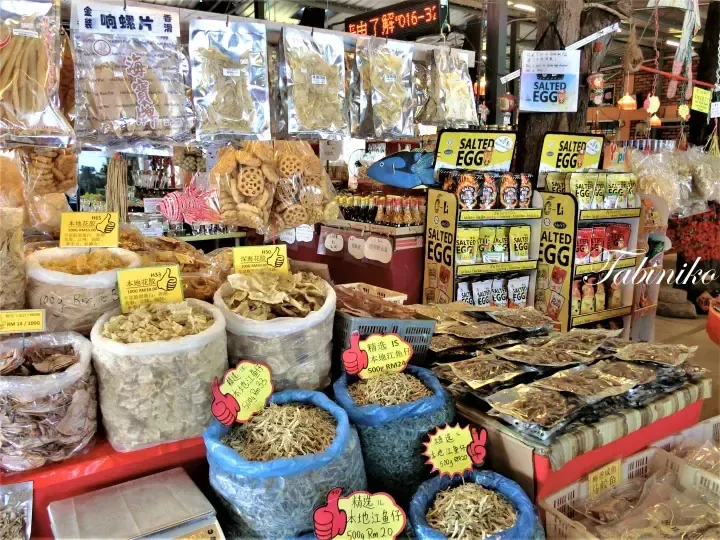 Dried seafood and salted egg snacks displayed at a market stall in Malaysia.