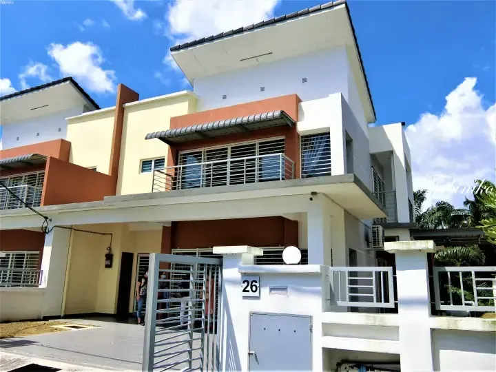 Modern two-storey terrace house with white and terracotta exterior, balcony, and metal gate under a blue sky.