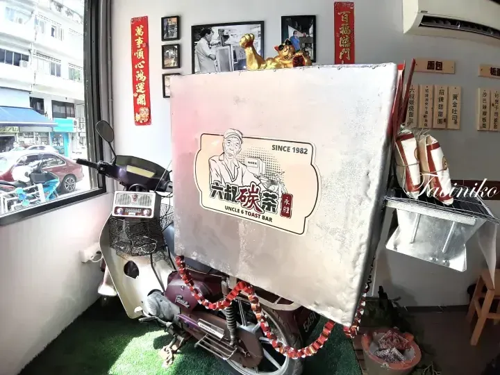 Uncle 6 Toast Bar interior featuring a vintage motorcycle with a large sign displaying the logo and &lsquo;Since 1982&rsquo; text.