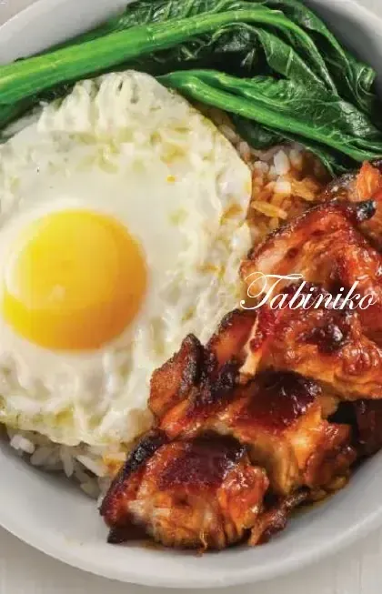 A bowl of rice topped with roasted chicken, a sunny-side-up egg, and blanched greens.