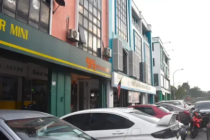 99 Speedmart storefront with Pertubuhan Ikram Malaysia sign on a street in Malaysia