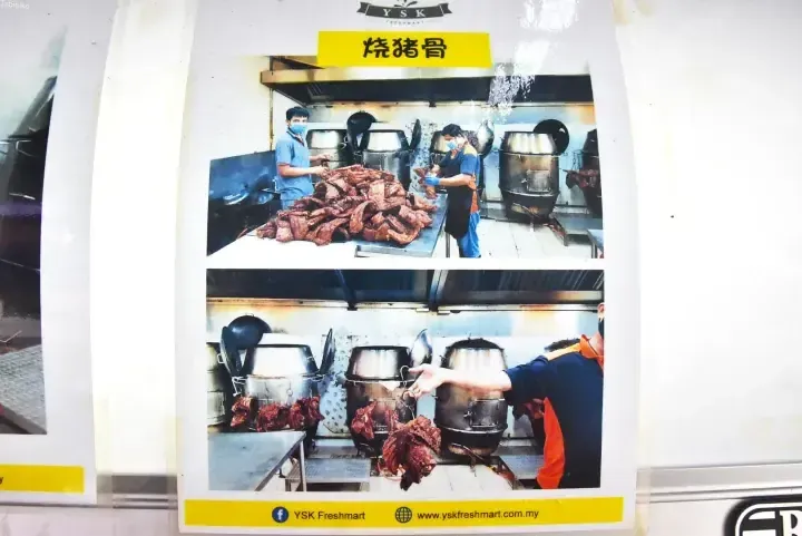 Workers preparing roasted pork bones at YSK Freshmart’s kitchen facility.