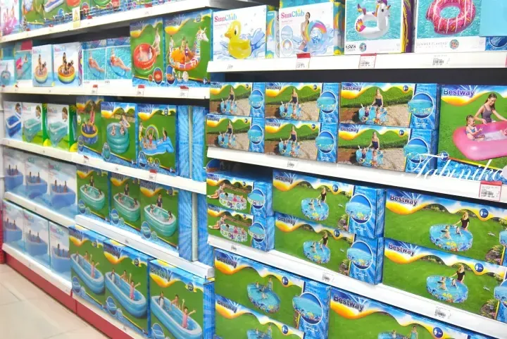 Shelves stocked with Bestway and SunClub inflatable pools and pool floats in a Malaysian retail store.