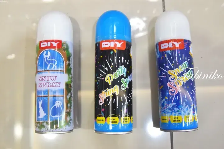 MR DIY brand party supplies including snow spray and string spray cans displayed on a store shelf.